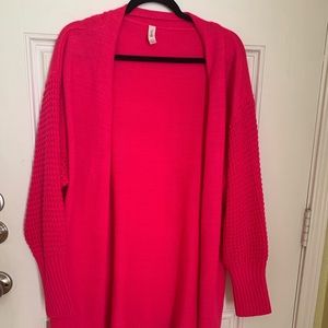 Honey Me sweater with waffle weave sleeves. Bright pink.